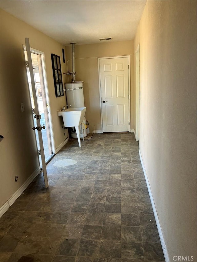 10178 Olivine Rd, Victorville, CA 92392 - corridor with strapped water heater and a sink