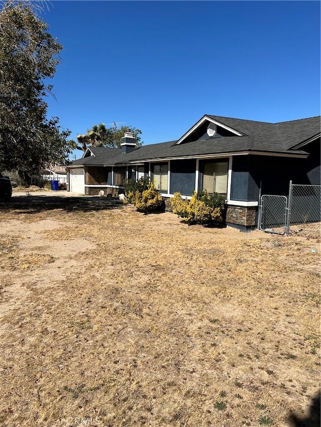 10178 Olivine Rd, Victorville, CA 92392 - view of front facade featuring stone siding and a garage