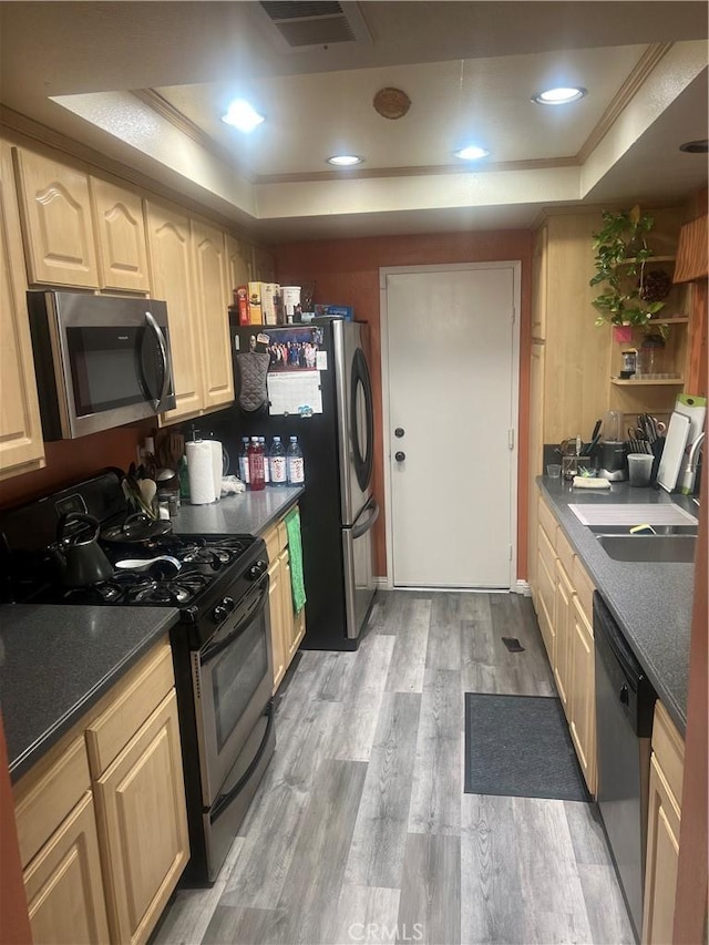 1522 Lahaina St, West Covina, CA 91792 - kitchen with appliances with stainless steel finishes, a raised ceiling, light wood-type flooring, and dark countertops
