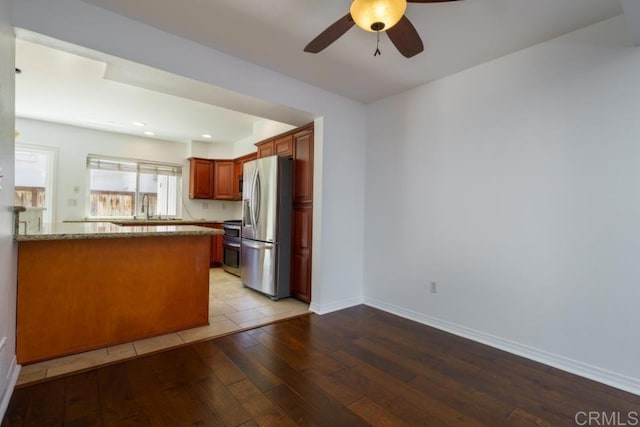 1651 S Juniper St Unit 172, Escondido, CA 92025 - kitchen featuring stainless steel fridge, light wood-style flooring, a ceiling fan, a peninsula, and range