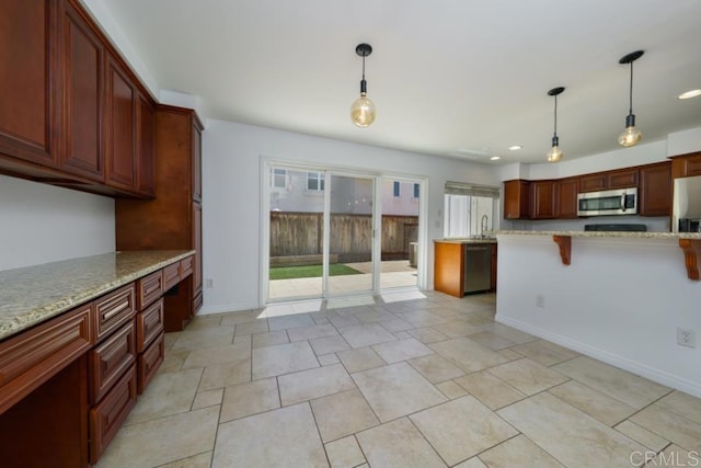1651 S Juniper St Unit 172, Escondido, CA 92025 - kitchen with stainless steel appliances, a breakfast bar area, light stone countertops, decorative light fixtures, and recessed lighting