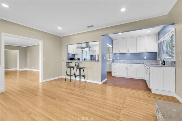 918 Dorothea Rd, La Habra Heights, CA 90631 - kitchen with light wood-style floors, white cabinets, crown molding, and recessed lighting