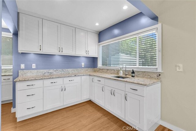 918 Dorothea Rd, La Habra Heights, CA 90631 - kitchen featuring white cabinetry, light wood finished floors, and light stone counters