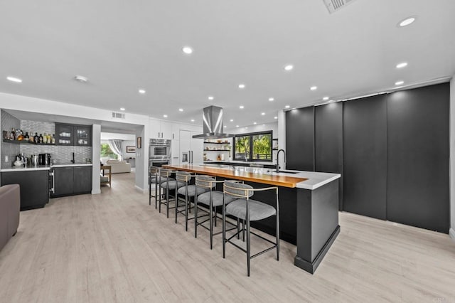 20 Lake Helix Dr, La Mesa, CA 91941 - kitchen with island range hood, a spacious island, stainless steel double oven, healthy amount of natural light, and recessed lighting