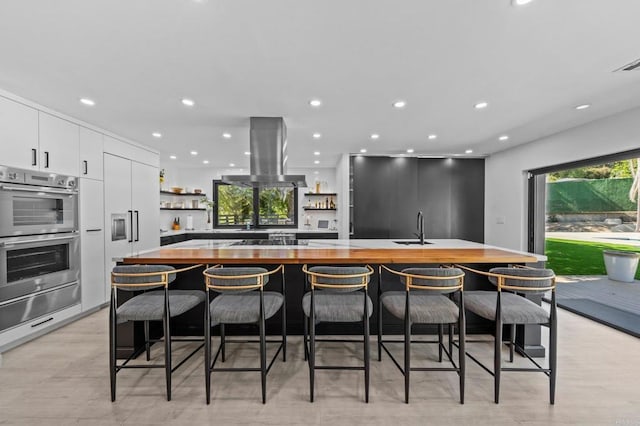 20 Lake Helix Dr, La Mesa, CA 91941 - kitchen featuring wood counters, double oven, island range hood, a warming drawer, and open shelves