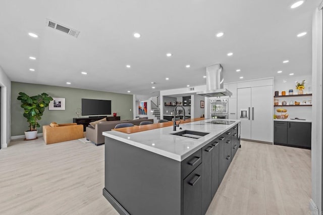 20 Lake Helix Dr, La Mesa, CA 91941 - kitchen with island exhaust hood, modern cabinets, an island with sink, light wood-type flooring, and stainless steel double oven