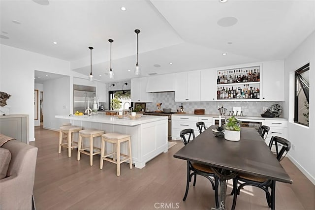 21611 Ocean Vista Dr, Laguna Beach, CA 92651 - kitchen with built in fridge, decorative backsplash, open shelves, light wood-style floors, and a spacious island