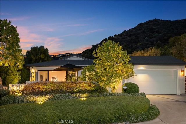21611 Ocean Vista Dr, Laguna Beach, CA 92651 - view of front of property featuring concrete driveway, a front yard, an attached garage, and a mountain view