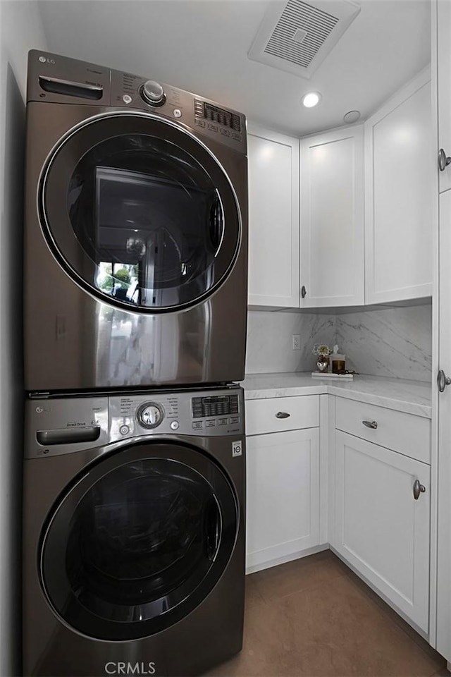 21611 Ocean Vista Dr, Laguna Beach, CA 92651 - washroom with stacked washing machine and dryer, cabinet space, and recessed lighting