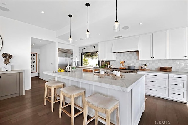 21611 Ocean Vista Dr, Laguna Beach, CA 92651 - kitchen with built in fridge, dark wood-type flooring, backsplash, white cabinets, and recessed lighting
