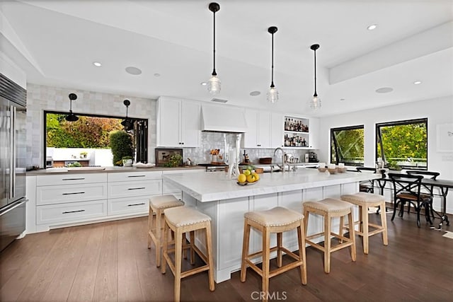 21611 Ocean Vista Dr, Laguna Beach, CA 92651 - kitchen with premium range hood, hardwood / wood-style floors, backsplash, stainless steel built in refrigerator, and recessed lighting