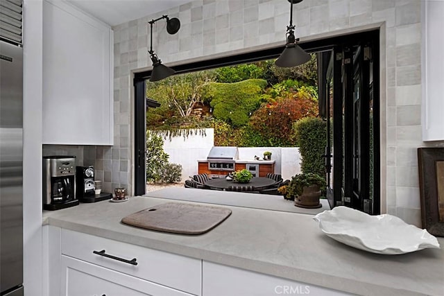 21611 Ocean Vista Dr, Laguna Beach, CA 92651 - kitchen featuring white cabinets, hanging light fixtures, tile walls, and built in fridge