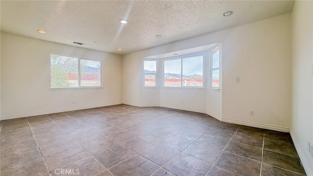 11126 Arena Rd, Pinon Hills, CA 92372 - spare room with healthy amount of natural light, a textured ceiling, and recessed lighting