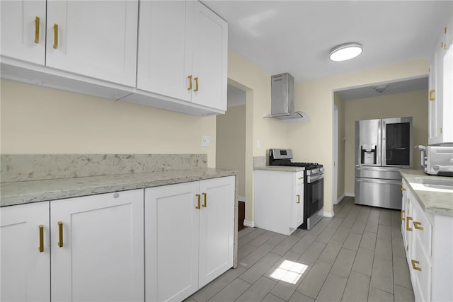 6059 Riverside Ave, Huntington Park, CA 90255 - kitchen with stainless steel appliances, wall chimney exhaust hood, white cabinets, and light stone counters
