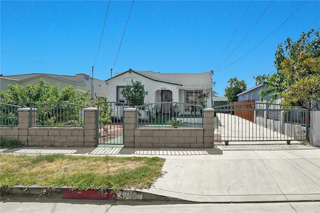 6059 Riverside Ave, Huntington Park, CA 90255 - view of front facade featuring a fenced front yard, a gate, and stucco siding