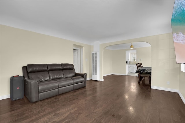 6059 Riverside Ave, Huntington Park, CA 90255 - living room with a heating unit, wood finished floors, arched walkways, and a ceiling fan