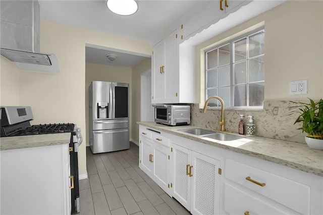 6059 Riverside Ave, Huntington Park, CA 90255 - kitchen featuring stainless steel appliances, wall chimney exhaust hood, white cabinets, and decorative backsplash