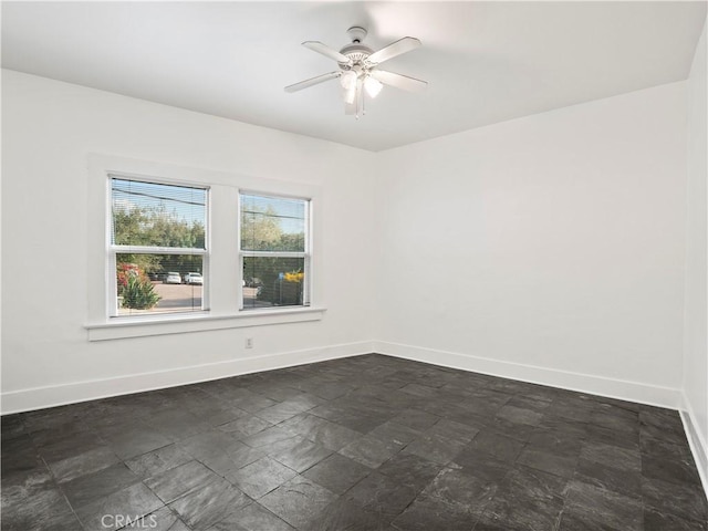 117 N Toluca St, Los Angeles, CA 90026 - spare room with a ceiling fan and dark stone finish flooring