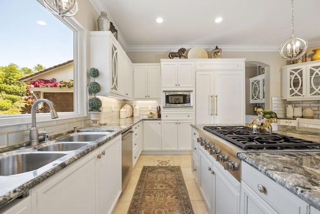 17150 Tallow Tree Ln, San Diego, CA 92127 - kitchen with stainless steel appliances, backsplash, white cabinets, light stone countertops, and ornamental molding