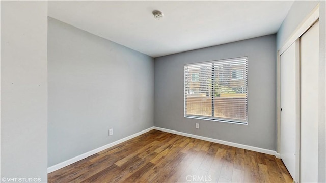 9020 Newport Ave Unit 17, Fontana, CA 92335 - unfurnished bedroom featuring wood-type flooring and a closet