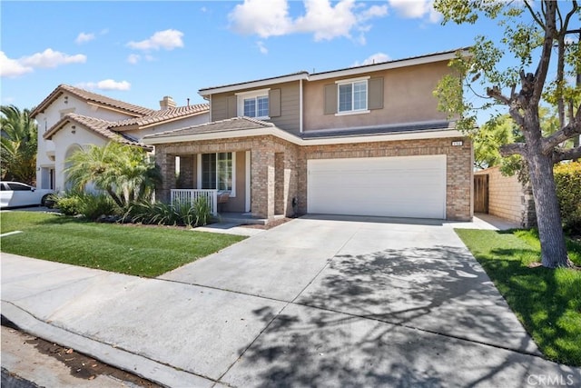 154 Fernpine Ln, Pomona, CA 91767 - view of front of house with covered porch, driveway, a garage, a front yard, and brick siding