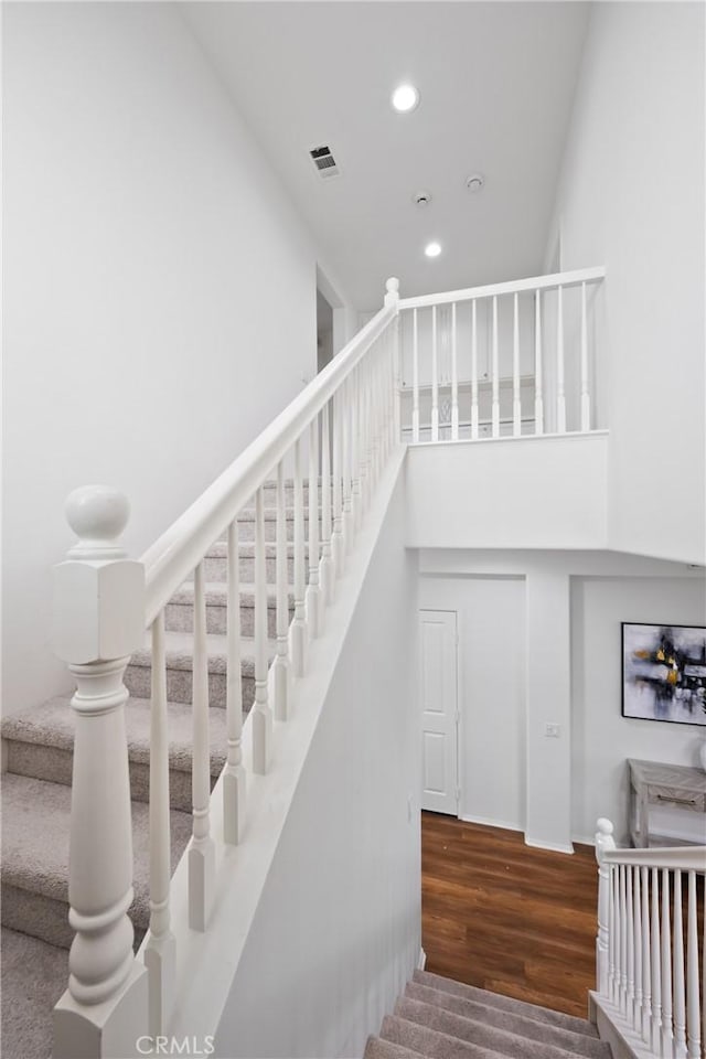 154 Fernpine Ln, Pomona, CA 91767 - staircase with recessed lighting, wood finished floors, and a towering ceiling