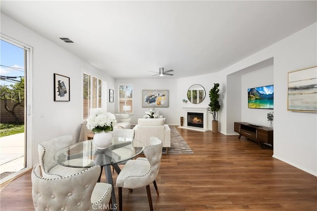 154 Fernpine Ln, Pomona, CA 91767 - dining area featuring a ceiling fan, a glass covered fireplace, and wood finished floors