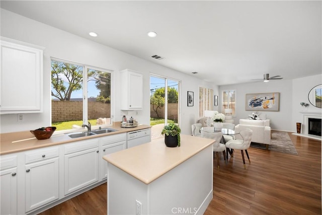 154 Fernpine Ln, Pomona, CA 91767 - kitchen with white dishwasher, open floor plan, a center island, white cabinets, and recessed lighting