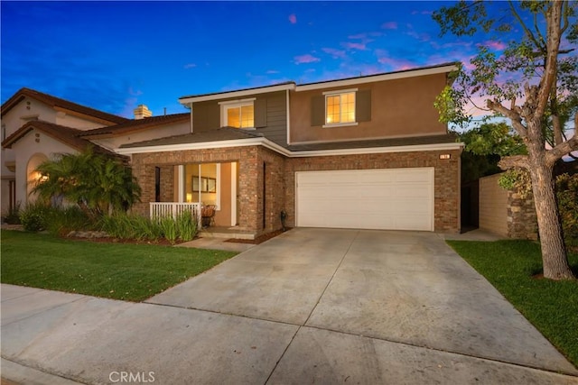 154 Fernpine Ln, Pomona, CA 91767 - view of front facade with covered porch, a garage, a yard, driveway, and brick siding