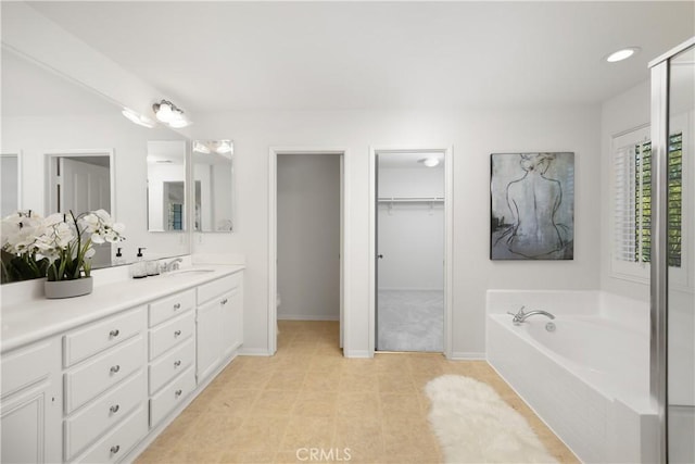 154 Fernpine Ln, Pomona, CA 91767 - bathroom featuring vanity, a bath, a spacious closet, and tile patterned floors
