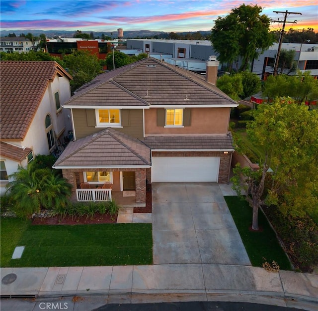 154 Fernpine Ln, Pomona, CA 91767 - traditional-style home with covered porch, stucco siding, concrete driveway, a tiled roof, and a garage