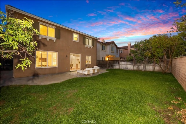 154 Fernpine Ln, Pomona, CA 91767 - back of house at dusk featuring stucco siding, a fenced backyard, and a patio area