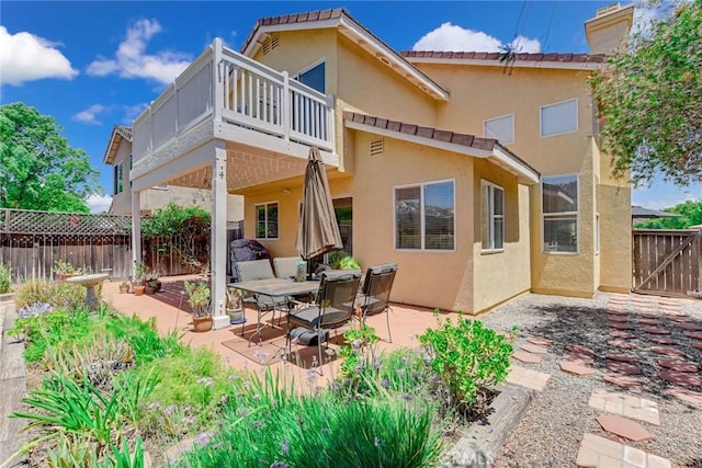 30747 Loma Linda Rd, Temecula, CA 92592 - back of house featuring stucco siding, a patio, and a chimney