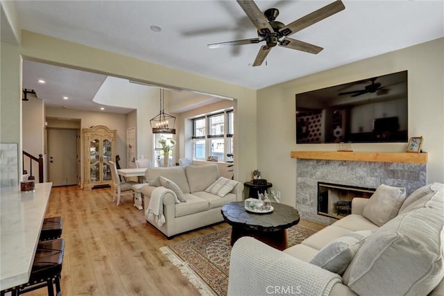 2000 San Antonio Dr, Corona, Corona, CA 92882 - living room with stairs, light wood-style flooring, ceiling fan, a glass covered fireplace, and recessed lighting