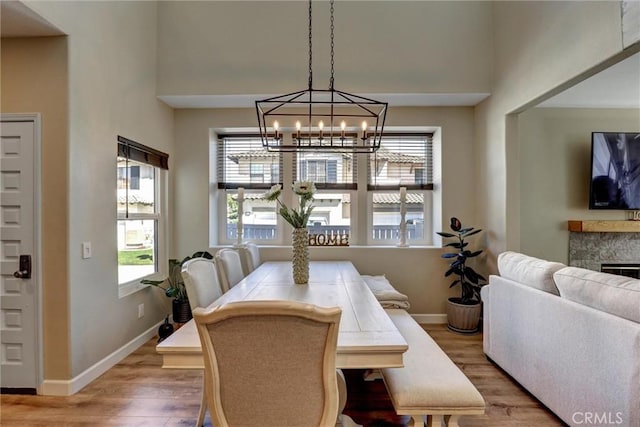 2000 San Antonio Dr, Corona, Corona, CA 92882 - dining area featuring wood finished floors, a chandelier, and a fireplace