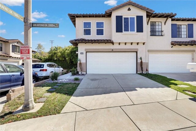 2000 San Antonio Dr, Corona, Corona, CA 92882 - mediterranean / spanish home with a tiled roof, stucco siding, an attached garage, and concrete driveway