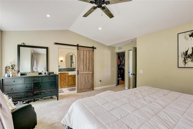 2000 San Antonio Dr, Corona, Corona, CA 92882 - bedroom with a barn door, vaulted ceiling, light carpet, connected bathroom, and a walk in closet