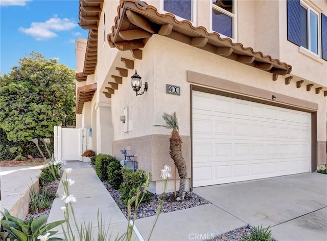 2000 San Antonio Dr, Corona, Corona, CA 92882 - property entrance with stucco siding, a garage, and concrete driveway