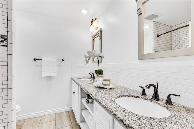 33554 Halyard Dr, Dana Point, CA 92629 - bathroom featuring double vanity, a tile shower, and tasteful backsplash