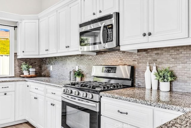 33554 Halyard Dr, Dana Point, CA 92629 - kitchen featuring appliances with stainless steel finishes, white cabinetry, backsplash, and light stone countertops