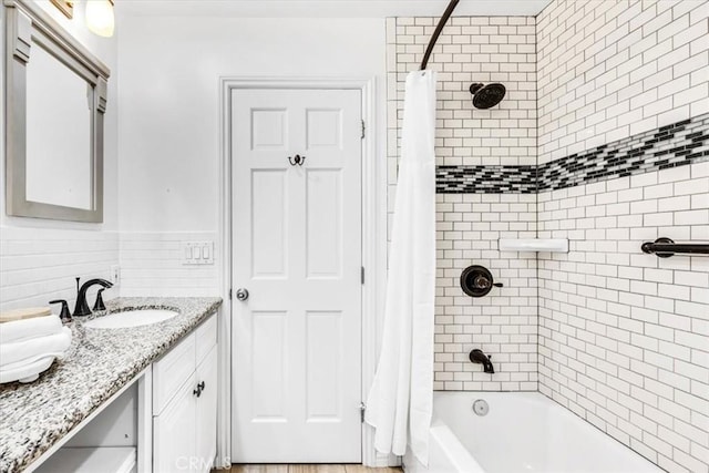 33554 Halyard Dr, Dana Point, CA 92629 - bathroom featuring vanity, shower / tub combo with curtain, wainscoting, and tile walls