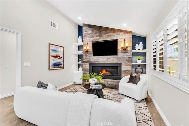 33554 Halyard Dr, Dana Point, CA 92629 - living room featuring lofted ceiling, wood finished floors, a large fireplace, and recessed lighting