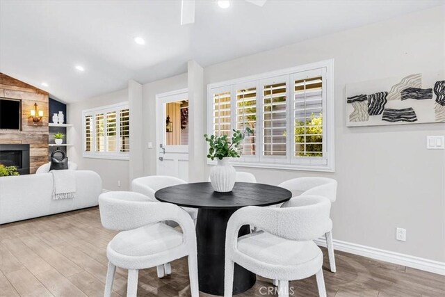 33554 Halyard Dr, Dana Point, CA 92629 - dining room featuring vaulted ceiling, wood finished floors, recessed lighting, and a large fireplace