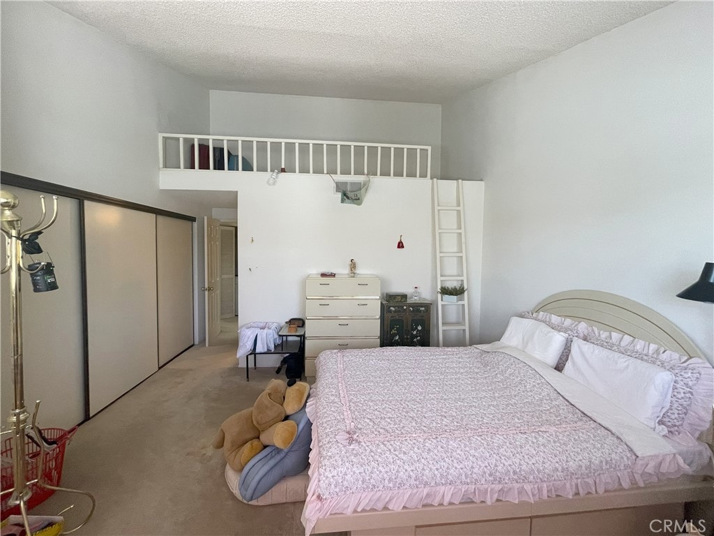 711 S Del Mar Ave Unit G, San Gabriel, CA 91776 - bedroom with carpet floors, a closet, and a textured ceiling
