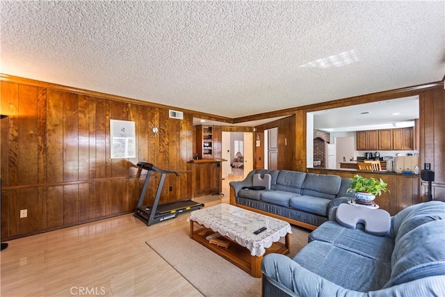 1825 Calle Madrid, Rowland Heights, CA 91748 - living room featuring wooden walls, a textured ceiling, ornamental molding, and light floors