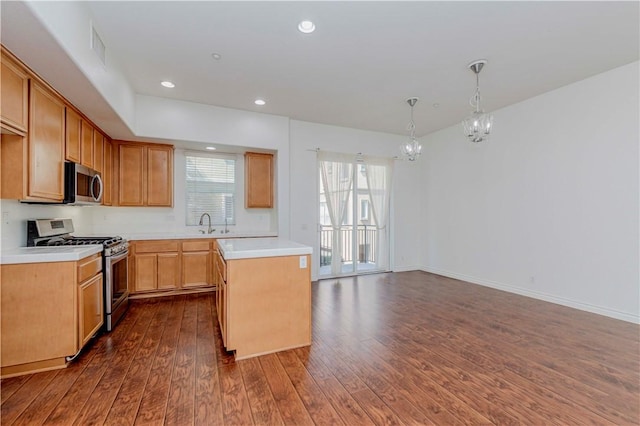 2245 Chaffee St, Fullerton, CA 92833 - kitchen with stainless steel appliances, a chandelier, dark wood-style floors, light countertops, and pendant lighting