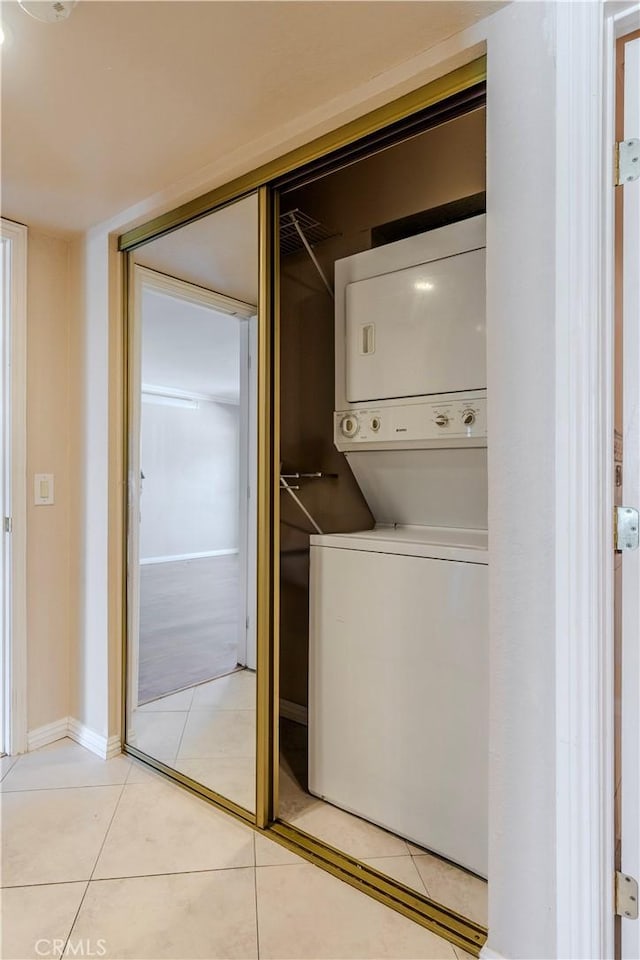 1620 Neil Armstrong St Unit 306, Montebello, CA 90640 - washroom with stacked washer and clothes dryer and light tile patterned floors