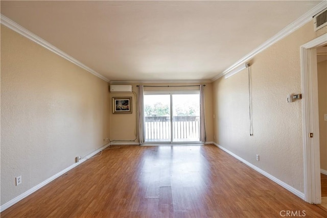 1620 Neil Armstrong St Unit 306, Montebello, CA 90640 - spare room featuring a wall mounted AC, wood finished floors, crown molding, and a textured wall