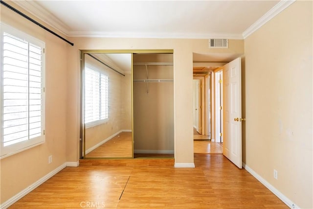 1620 Neil Armstrong St Unit 306, Montebello, CA 90640 - unfurnished bedroom featuring light wood finished floors, ornamental molding, and a closet