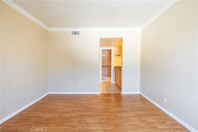 1620 Neil Armstrong St Unit 306, Montebello, CA 90640 - spare room featuring crown molding and light wood-style flooring